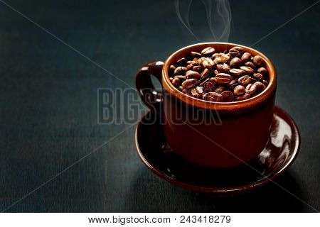 Cup Of Coffee Full Of Coffee Beans.