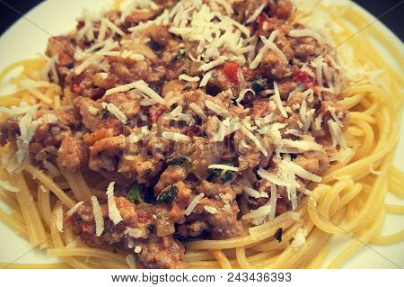 Appetizing Spaghetti In A Plate With Bolognese Sauce On A Dark Background Close Up