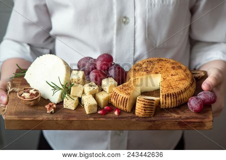 Cheese Platter In Hands Of Cheese Maker
