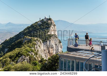 Gibraltar, Uk - May 18, 2017: Tourists And Barbary Apes On The Viewing Platform With The Rock And Th
