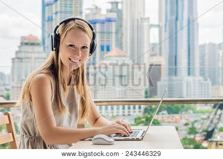 Young Woman Teaches A Foreign Language Or Learns A Foreign Language On The Internet On Her Balcony A