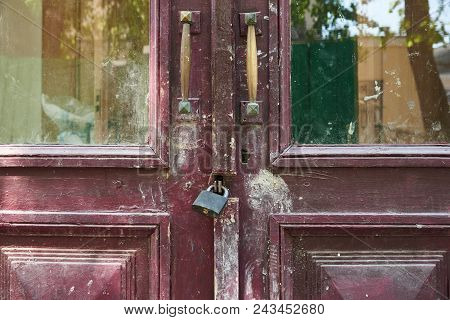 Fragment Of An Old Wooden Door Closed On A Padlock