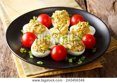 Delicious Snack: Stuffed Eggs With Tuna, Avocado Served With Tomatoes And Green Onions Close-up On A