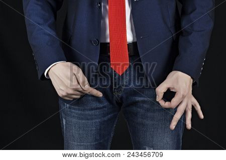Man In Suit Businessman Holding On Inguinal Area And Showing Gesture Class, Black Background, Viagra