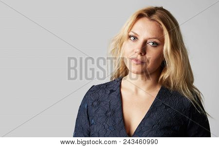 Fashion Photo Of A Beautiful Blonde Woman In A Pretty Dress Posing Over Gray Empty Background. Fashi