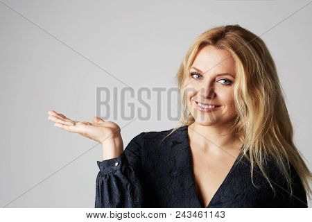 Fashion Close Up Photo Of A Beautiful Blonde Woman In A Pretty Dress Posing With Hand Over Gray Empt