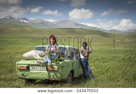 Family With Their Car In A Countryside