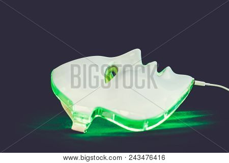 Light Rejuvenating Mask For Facial Skin Therapy On Black Background
