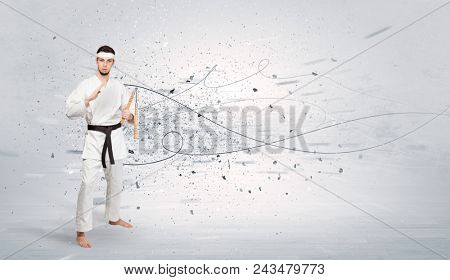 Young karate trainer doing karate tricks with chaotic concept