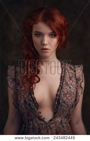 Dramatic Retro Portrait Of A Young Beautiful Dreamy Redhead Woman. Soft Vintage Toning.