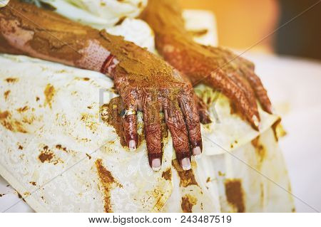Bride's Hand With Mehndi (henna Art) With Turmeric Pasted During Traditional Rituals Indian Marriage