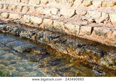 Old Ancient Yellow Stone Steps Covered With Brown Friable Sand With Waves And Irregularities, Descen