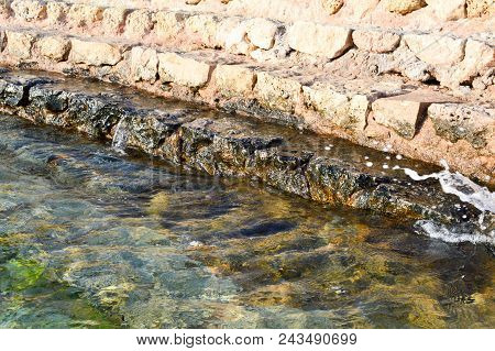 Old Ancient Yellow Stone Steps Covered With Brown Friable Sand With Waves And Irregularities, Descen