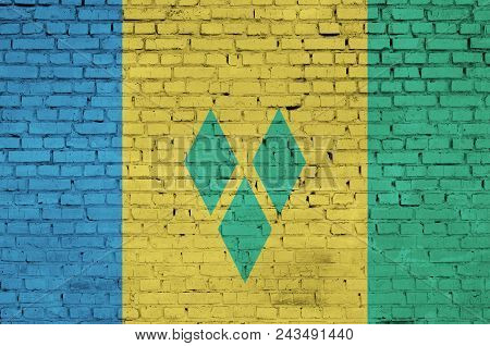 Saint Vincent And The Grenadines Flag Is Painted Onto An Old Brick Wall