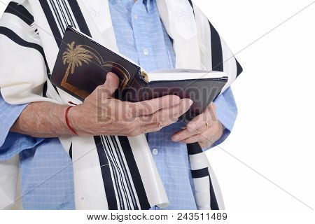 Eldery Jewish Man With Kippah And Wrapped In Talit Praying With Siddur. Religion Concept