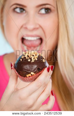 Diet, Sweets, Food Concept. Woman Holding Delicious Chocolate Cupcake With Peanut Frosting, Having W
