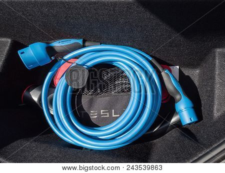 Urmond, Netherlands - May 31, 2018. Charging Cable Type2. Tesla Supercharge Station With A Car On Ch