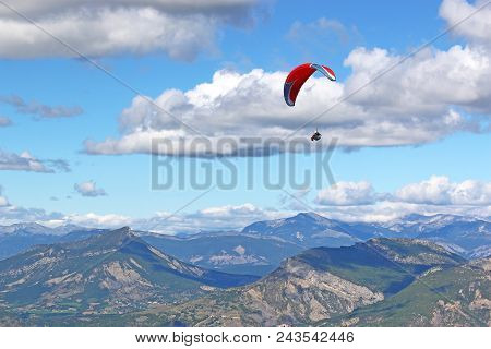 Paraglider Flying High In The French Alps