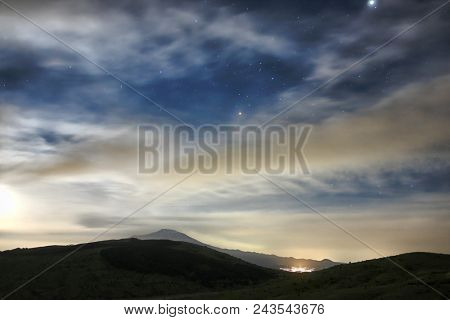 clouds and moon rise in the starry sky on Etna Mount, Sicily 