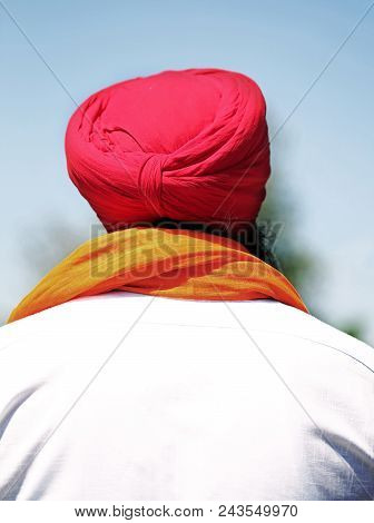 Man With Beard And Red Turban And White Shirt