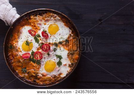 Three Fried Eggs With сherry Tomatoes In A Pan On A Black Background With Space