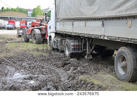 Heavy Recovery Tractor Pulling Semi Truck Stuck In Mud