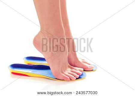 Female Feet Stand On Tiptoe In Orthopedic Insoles