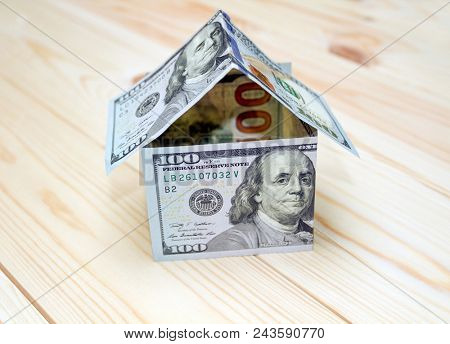 Dollars money in the shape of a house. Mortgage concept means hypothecation or instalments. House made of money