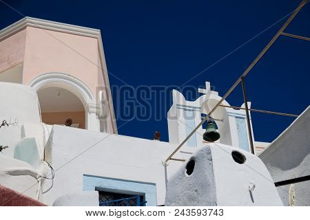 Orthodox Church Against A Blue Sky. Typical Mediterranean City Landscape. Santorini, Greece