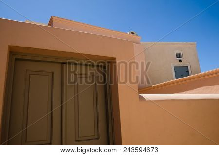 Main Door Entrance Against A Blue Summer Sky. Santorini Greece