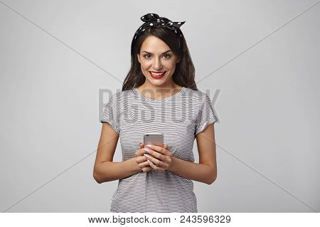 Isolated Shot Of Attractive Young Female Enjoying Online Communication Using High Speed Internet Con