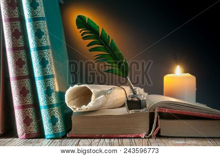 Green Quil Pen And Black Inkwell With Old Papers And Books