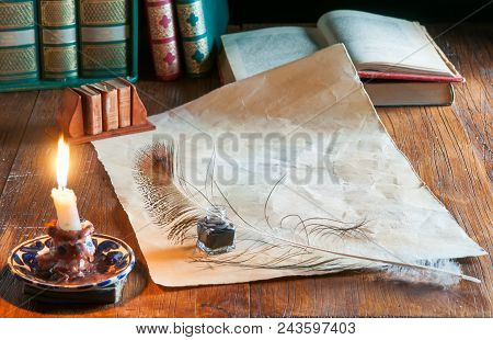 Green Quil Pen And Black Inkwell With Old Papers And Books