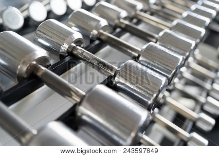 Rows Of Dumbbells In The Gym With Hign Contrast Light