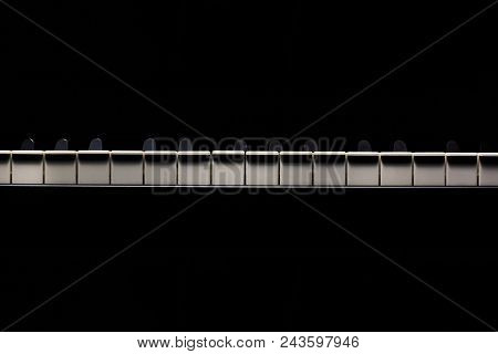 Black And White Piano Keys In Dark Ambiance. Accentuated Highlights.