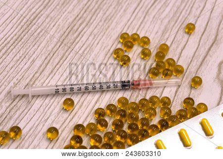 Ampoules And Syringe On White Background. Medical Ampoules With Syringe Isolated. Selective Focus. M