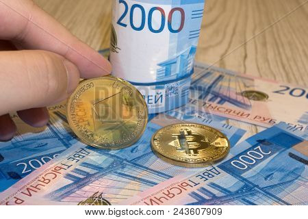 Gold Krypto Coins Bitcoin Btc, Paper Notes Of Russian Rubles. Metal Coins Are Laid Out In A Backgrou