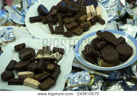 Various Chocolate Pralines Isolated On White Background. Top View