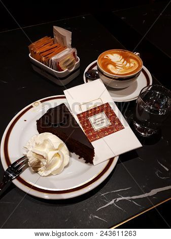 Vienna, Austria - December 16, 2017: Original Sacher Torte With Cream And Fork At Sacher Cafe