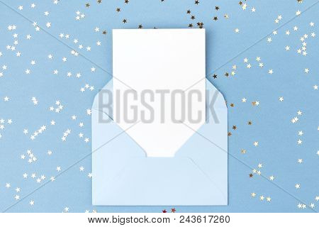 Empty Card In Blue Envelope On Blue Background Decorated With Confetti. Holiday And Invitation Mocku