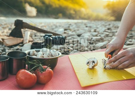 Woman Cooking On Camp Fire. Wild Nature Resting. Cutting Mushrooms