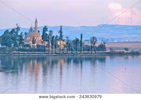 Architecture Of Hala Sultan Tekke With Cloudy Sky And Water Reflections