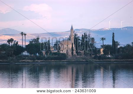 Architecture Of Hala Sultan Tekke With Cloudy Sky And Water Reflections