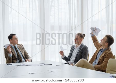 Business Men Launching Paper Planes At The Board Meeting. Idleness. Childish  Behavior At Work