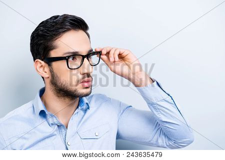 Portrait Of Virile Trendy Bachelor With Black Hair In Blue Shirt Casual Outfit Looking Away Holding 