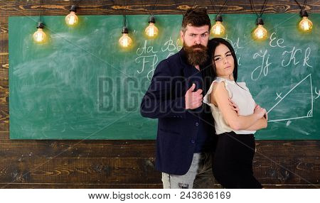 Teacher And Strict Schoolmaster Look Confident. Lady And Hipster Working Together In School. Partner