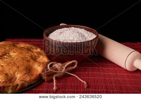 On A Dark Wooden Table, Fashionable Bakeries, A Bowl With Flour, Apricot Cake And Tools