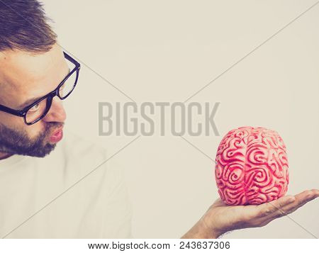 Adult Nerd Man Wearing Eyeglasses Looking At Human Brain Model. Thinking And Intelligence Conept