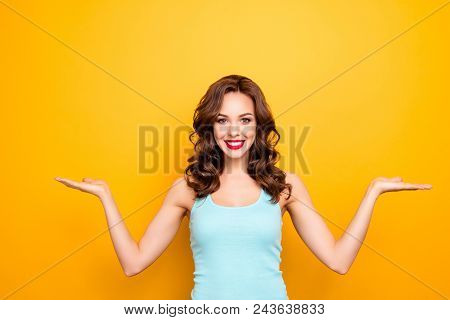 Portrait Of Cheerful Pretty Girl With Beaming Smile Holding Two Copyspace Empty Places On Palms Look