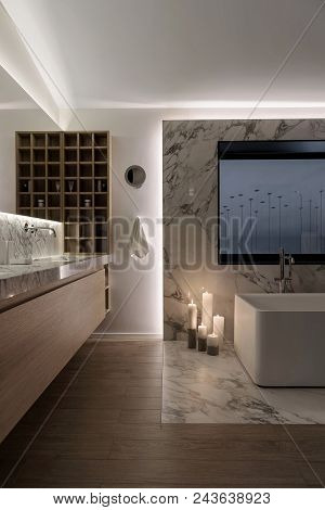 Luminous Modern Bathroom With White Wall And A Parquet On The Floor. There Is A Tiled Zone With A Wh